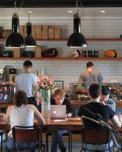 People working inside a NYC cafe