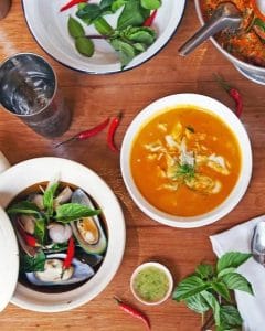 Image of different seafood dishes on a table including mussels