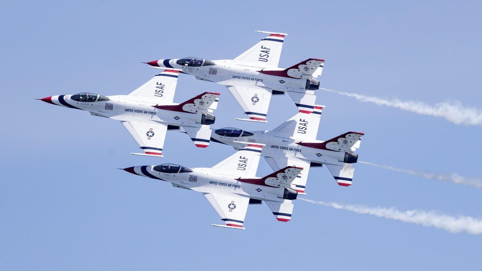 Four U.S. Air Force fighter jets fly in tight formation during an aerial demonstration at the FourLeaf Air Show at Jones Beach. This image is part of the blog post "Fun Things To Do in New York This May 2025."