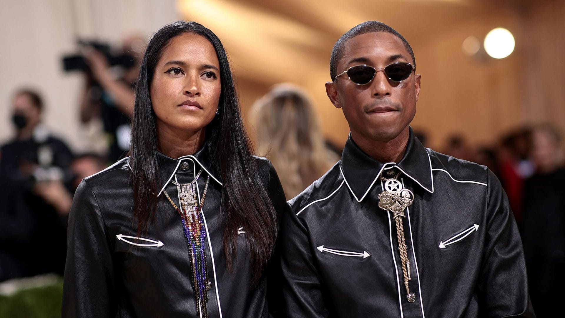Pharrell Williams attended the Met Gala 2021 wearing coordinated black leather outfits with bolo ties and statement jewelry. Image from Teenvogue.com for the blog post "Met Gala 2025: Celebrities, Red Carpet, Theme & More."