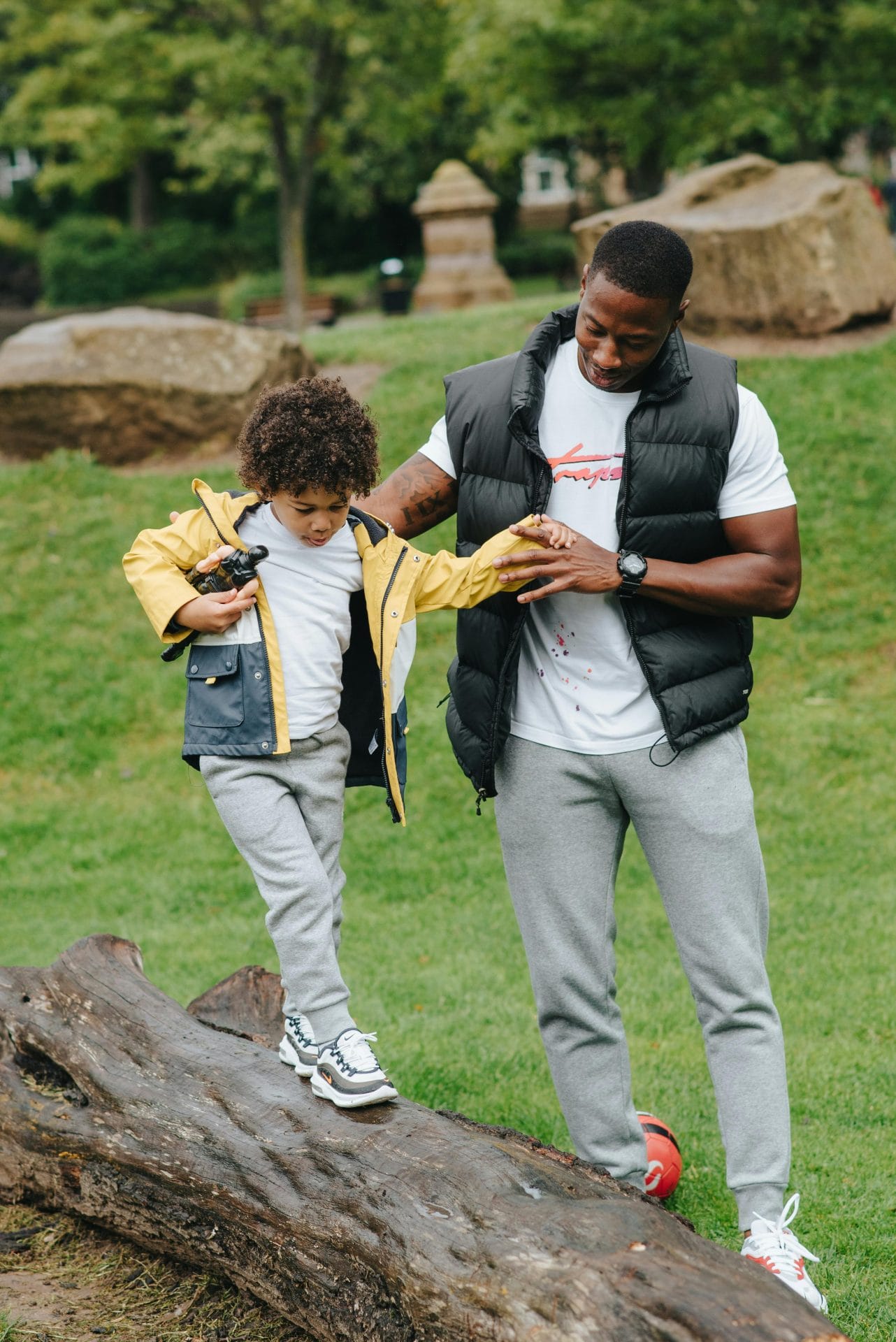 A child walking with his dad in a park