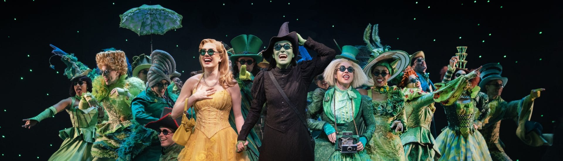 Actors from Wicked on stage.