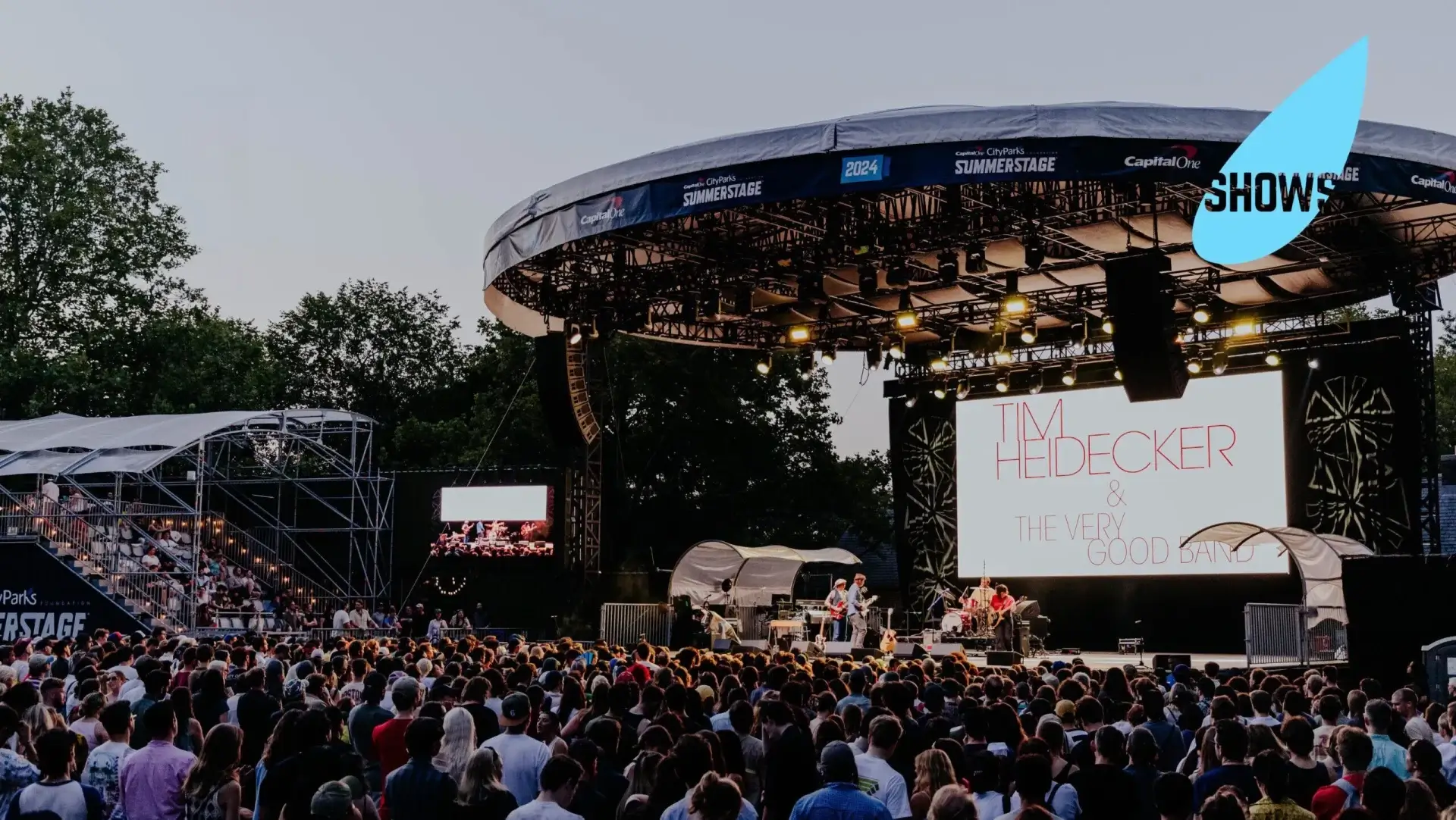 Performers on stage playing to a crowd for SummerStage