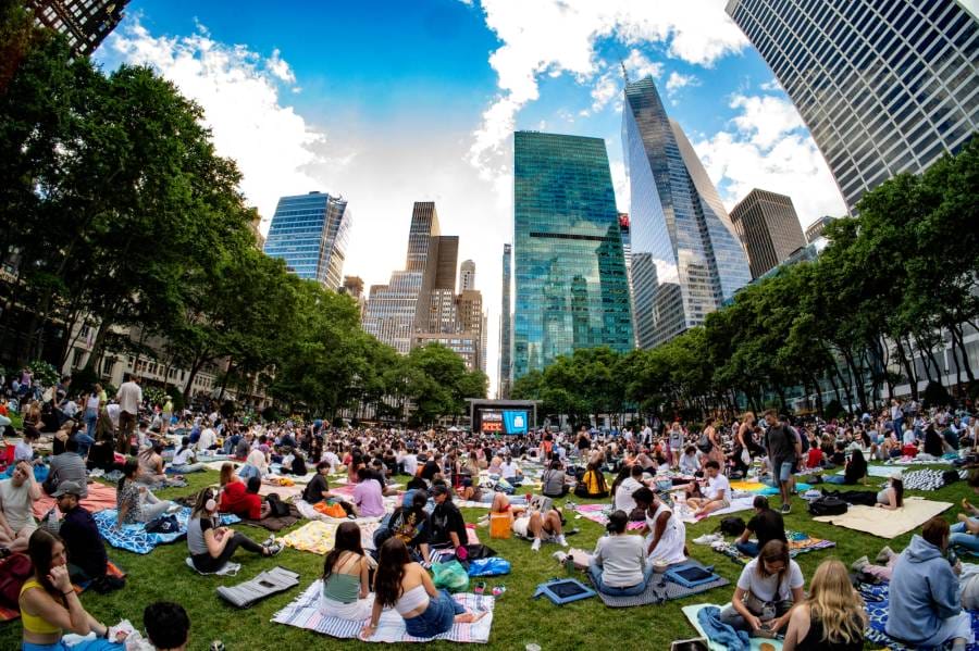People gathered and watching an outdoor movie at Bryant Park