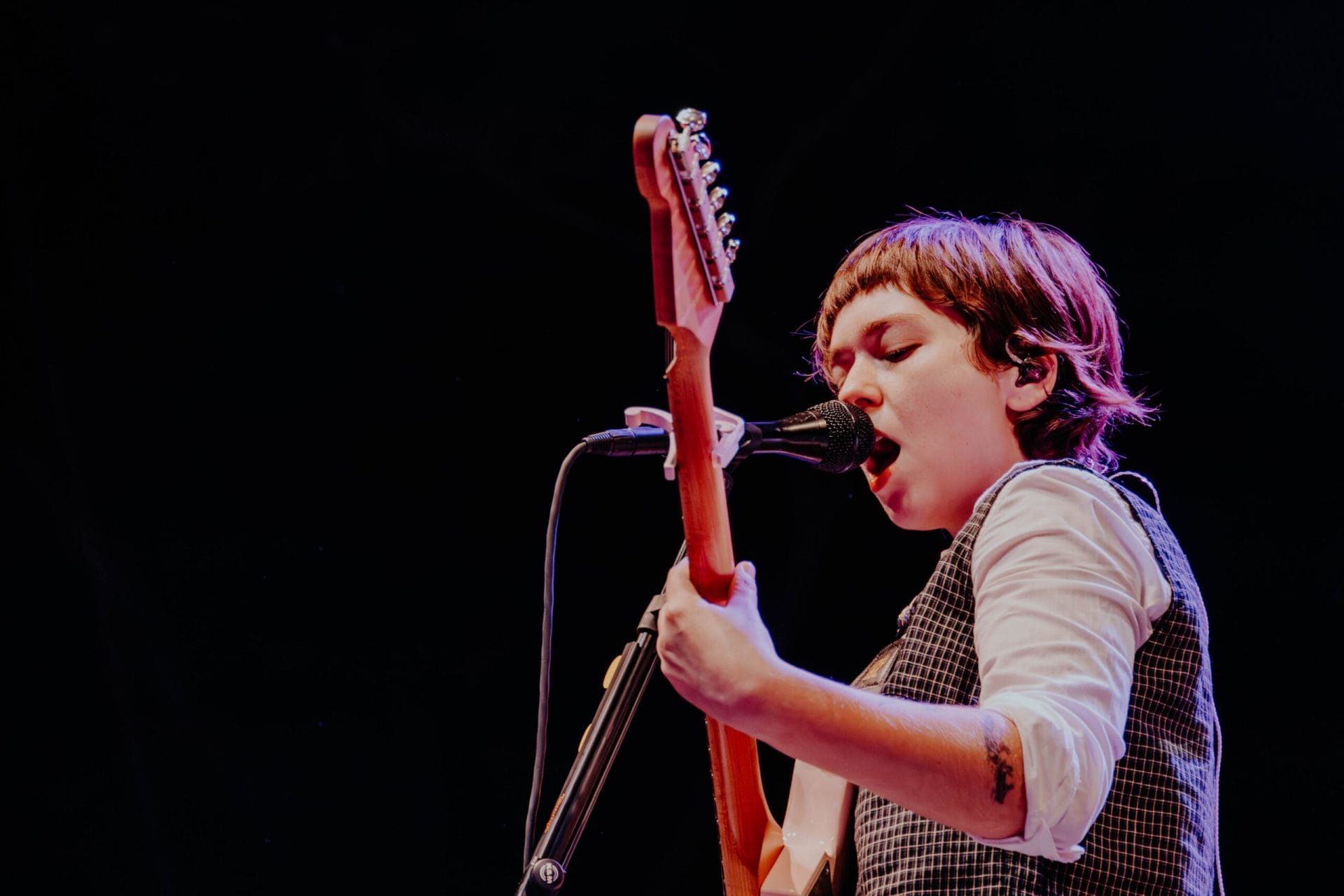 Artist Snailmail performing with a guitar and microphone at SummerStage