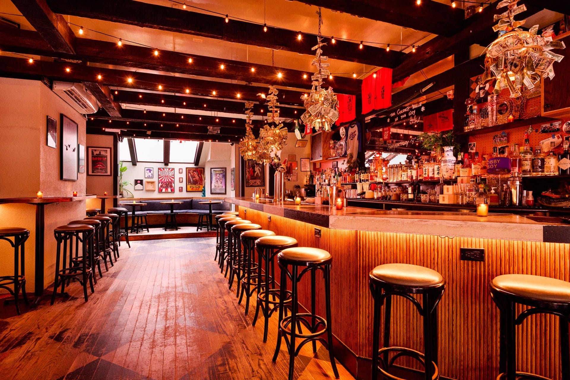 Wide shot of empty orange-lit bar.