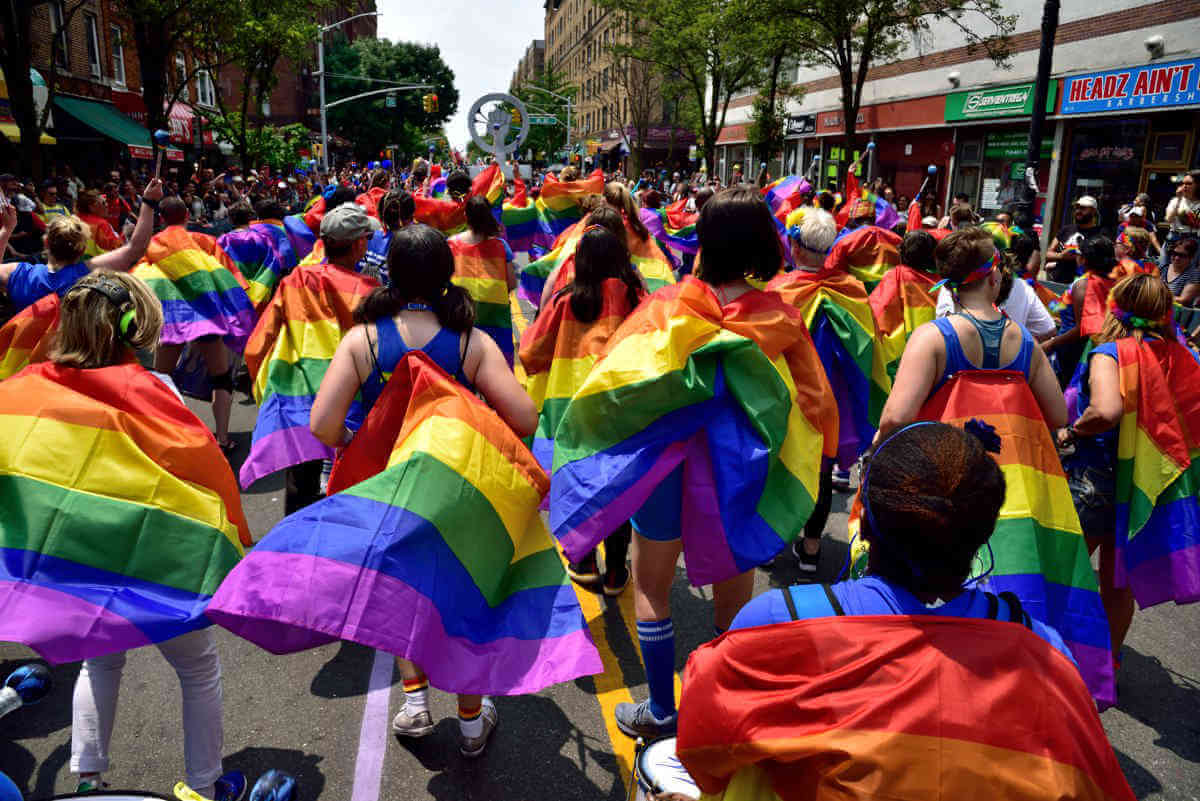 Crowd of people at the pride festival with 2LGBTQIA+ flags.