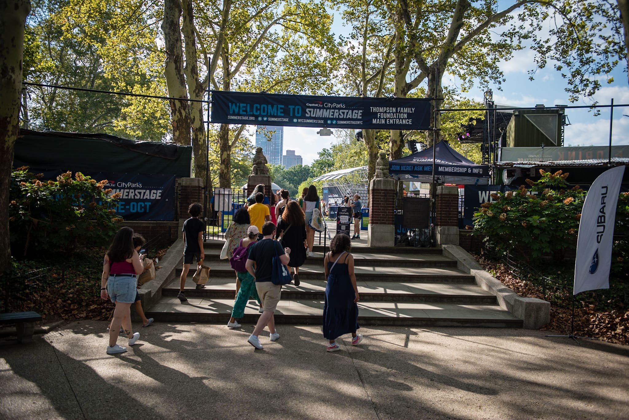 People entering a park that hosts a SummerStage concert