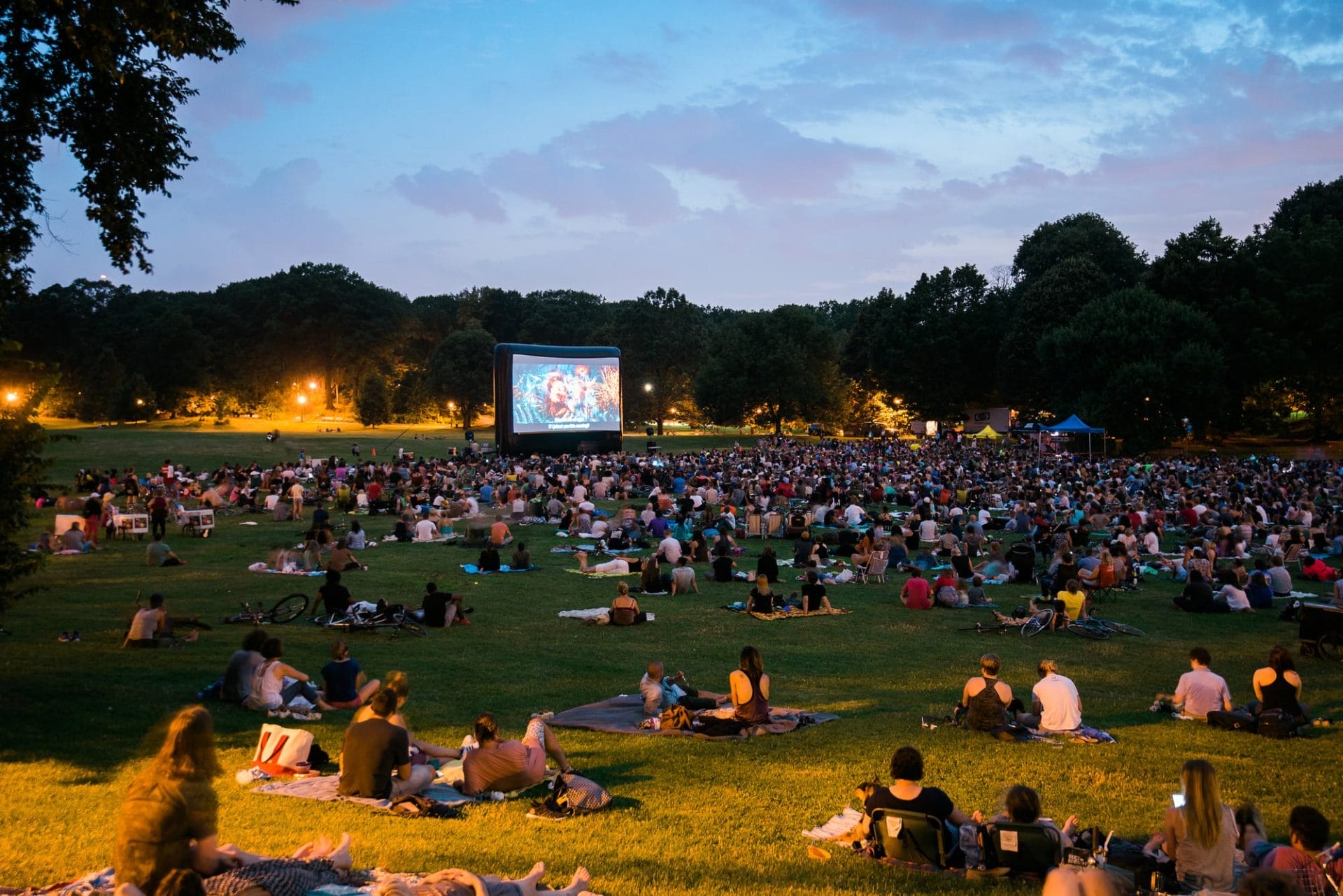 People gathered and watching an outdoor movie at Prospect Park