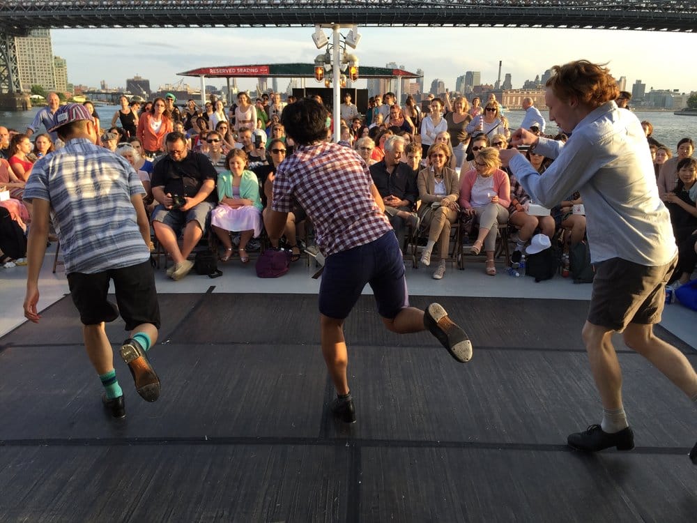 Tap dancers dancing on stage in front of a crowd