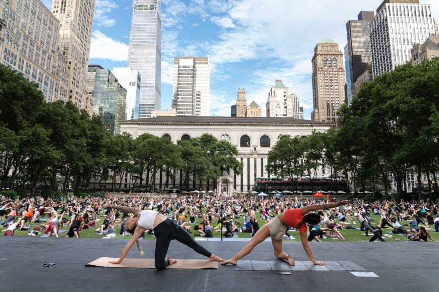 People gathered in Bryant Park doing yoga