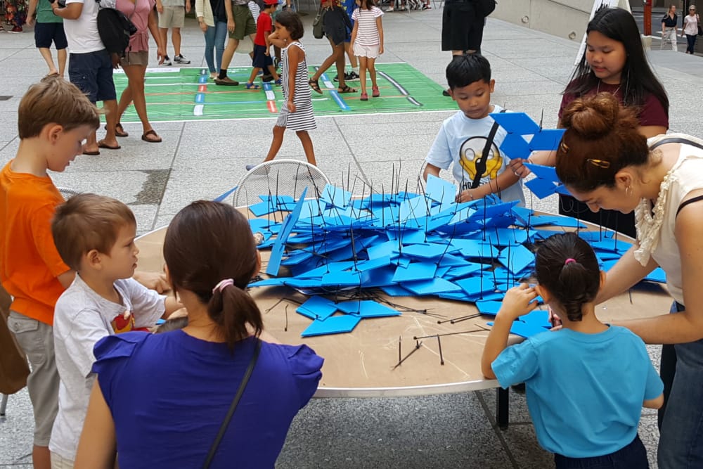 Kids of various ages participating in a game for the Math Festival
