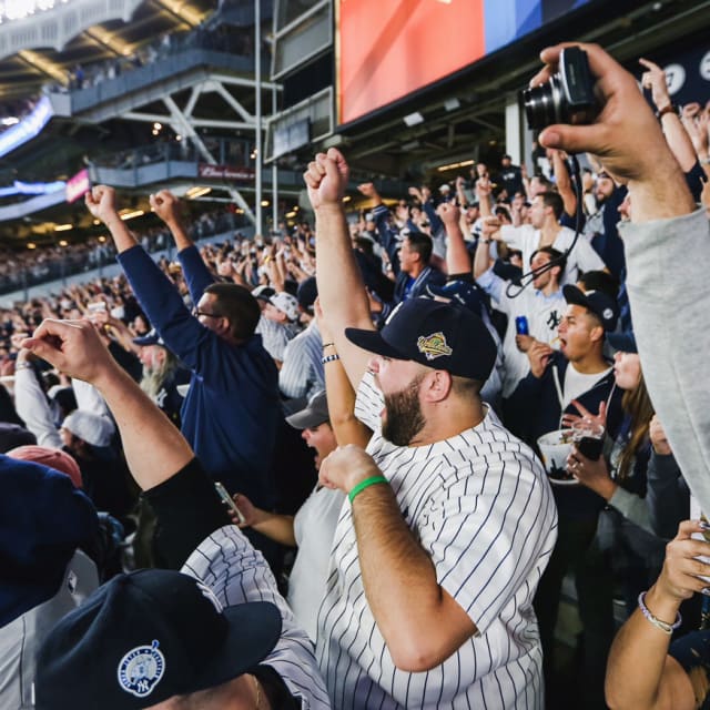 Shot of people cheering at a Yankees game.