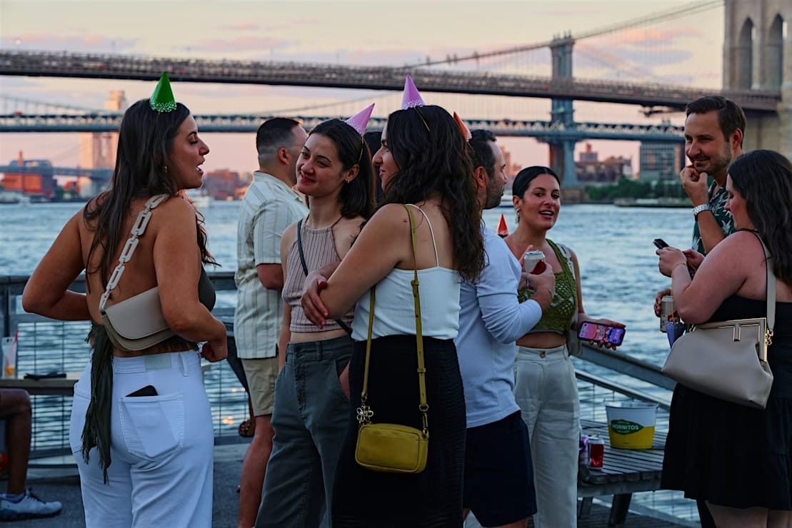 People gathered by the Brooklyn Bridge at Pier 15