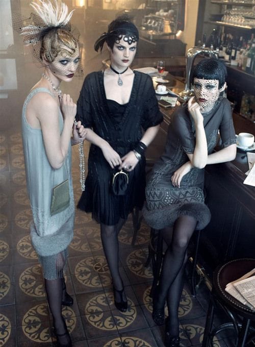 Three women dressed in Flapper era attire.