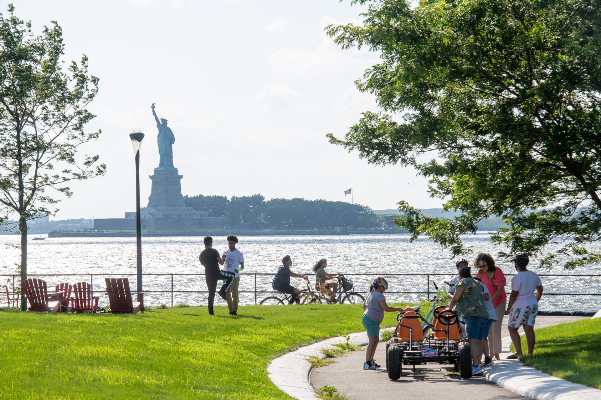 People gathered at Governors Island facing the Statue of Liberty