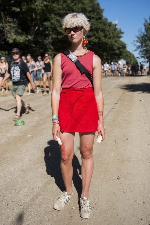 Person wearing a red top and red skirt with red earrings.