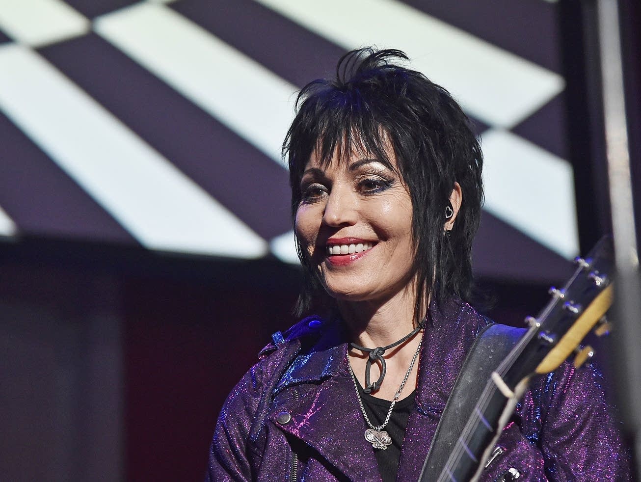Joan Jett on stage with a guitar