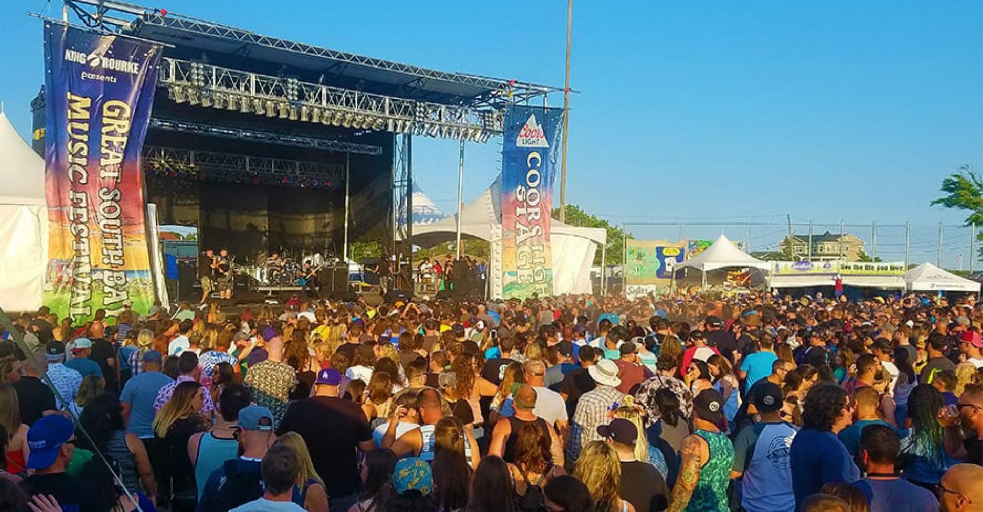 Wide shot of big crowd surrounding a stage