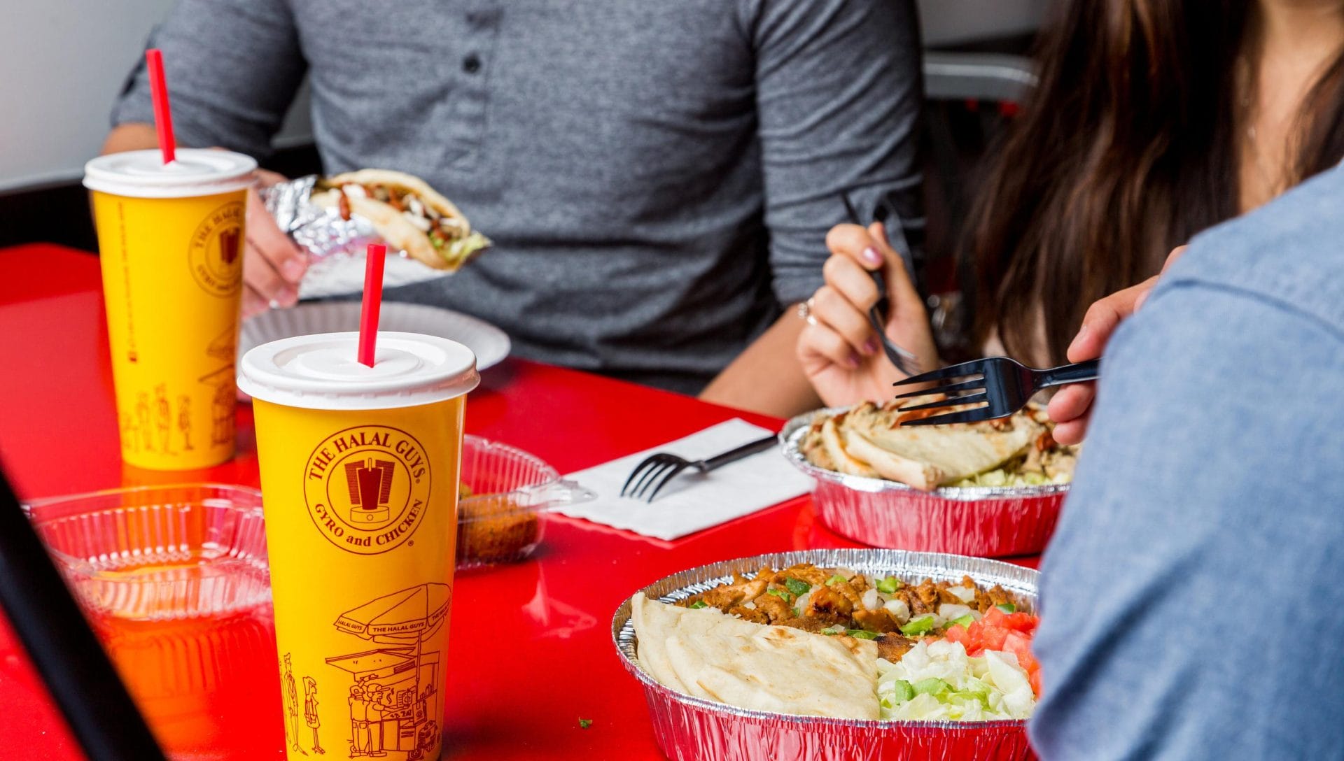 People eating Halal Guys dishes